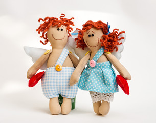 Doll angel with his hands on white background