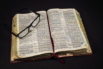 Well Studied Open Bible With Glasses