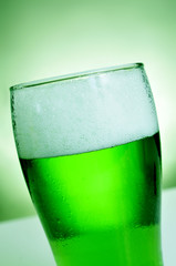 glass with dyed green beer