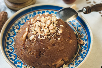 
semolina halva, halvah, halava sweet desert with raisiins and nuts