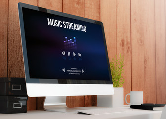 modern workspace with computer showing music streaming website