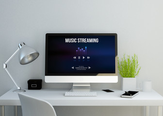 modern clean workspace with music streaming website on screen