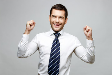 Handsome stylish businessman on grey background