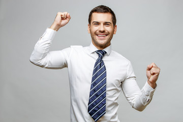 Handsome stylish businessman on grey background