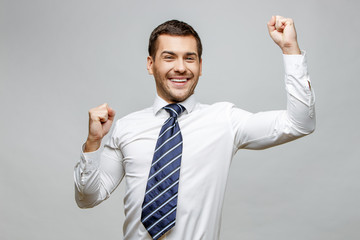 Handsome stylish businessman on grey background