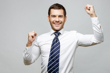 Handsome stylish businessman on grey background