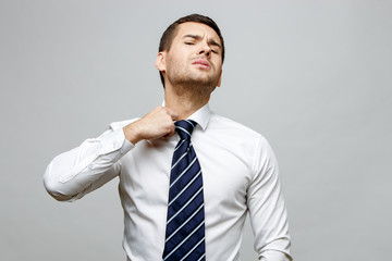 Handsome stylish businessman on grey background