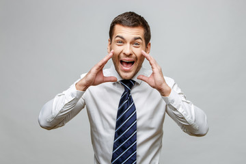 Handsome stylish businessman on grey background