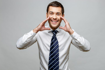 Handsome stylish businessman on grey background