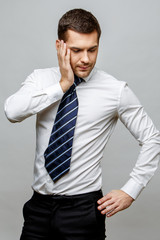 Handsome stylish businessman on grey background