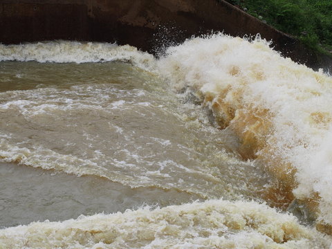 Turbulent  flow of water pass a weir after the rain