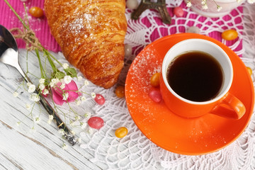 cup of coffee and croissant with the small Eiffel Tower