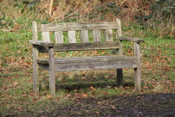 A Weathered Wooden Park Bench for Two People.