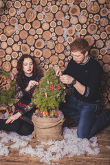 Christmas couple in a rural wooden house