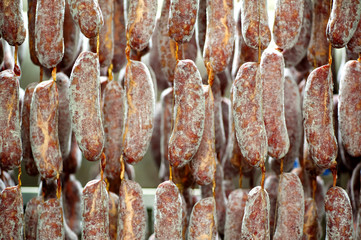 Freshly packed sausages curing in factory