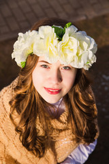 Beautiful young girl with a floral ornament in her hair