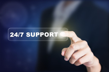 Businessman pressing a 24/7 SUPPORT concept button. Can be used in advertising.