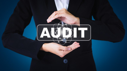 Business women holding posts in AUDIT. Can be used in advertising.