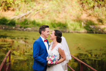 Beautiful couple at the wedding on a background of lake