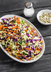 Cole slaw with seeds and pine nuts - delicious healthy vegetarian food. On a dark rustic wooden background