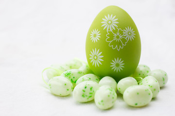 green and white painted egg on a white background 