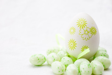 green and white painted egg on a white background 