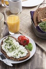 healthy spring summer low fat breakfast with orange juice,coffee,bread,cottage cheese, cress and tomatos