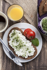 healthy spring summer low fat breakfast with orange juice,coffee,bread,cottage cheese, cress and tomatos
