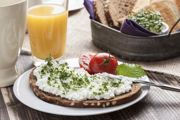 healthy spring summer low fat breakfast with orange juice,coffee,bread,cottage cheese, cress and tomatos
