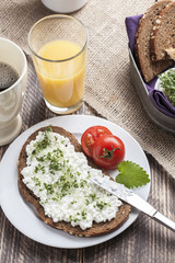 healthy spring summer low fat breakfast with orange juice,coffee,bread,cottage cheese, cress and tomatos
