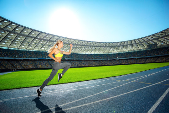 Young sportswoman is at large modern stadium