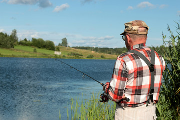 Fisherman with spinning on the water