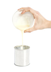 Woman hand pouring condensed milk into a tin can