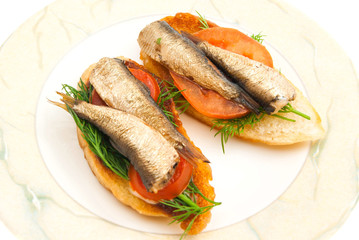 pair of sandwiches with sprats on a dish