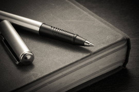 pen and book with filter effect retro vintage style