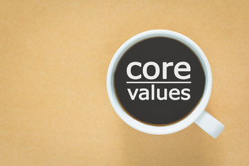 core values message coffee cup and business strategy on wooden table with retro filter effect