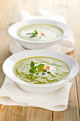 Green pea soup in bowls.