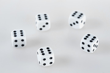 Five dices on a white table