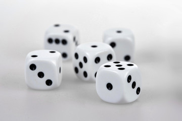Five dices on a white table