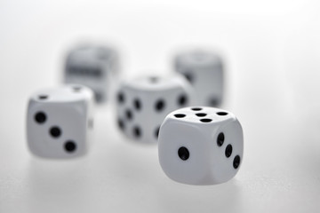 Five dices on a white table