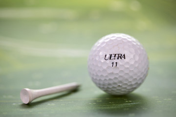 White golf ball and tee