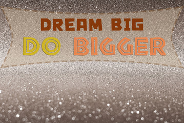 Dream big do bigger word on glitter abstract background