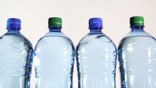 pure sparkling water poured into plastic bottles