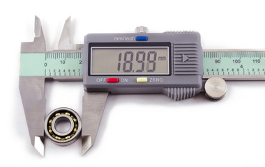 Bearing and electronic caliper on a white background