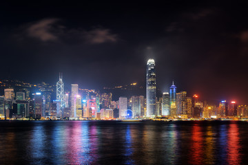 Fototapeta na wymiar Night view of skyscrapers on waterfront, Hong Kong