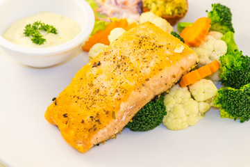 Fried salmon steak with vegetables