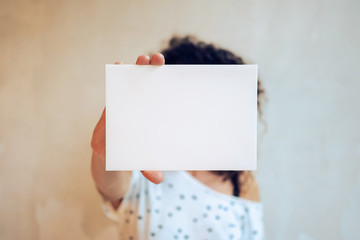 Young woman showing a blank page on a white background