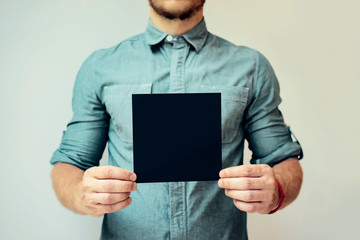 Young man showing a black blank page of clipboard