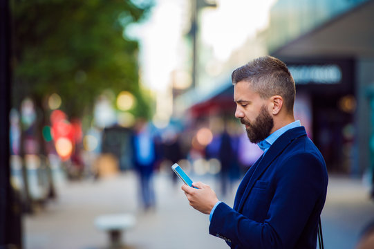 Hipster Manager Holding Smartphone, Texting Outside In The Stree