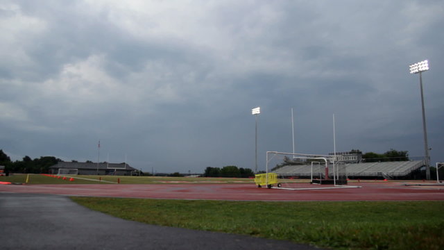 View of a high school football stadium as a storm approaches.